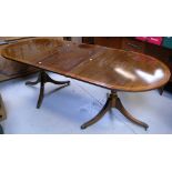 A reproduction mahogany dining table, part fluted supports to paw feet and castors, width 170cm.