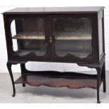 An early 20th century mahogany display cabinet with glazed doors and sides and velvet lined shelves