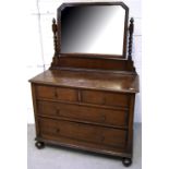 An early 20th century oak mirror back dressing table with barley twist supports,