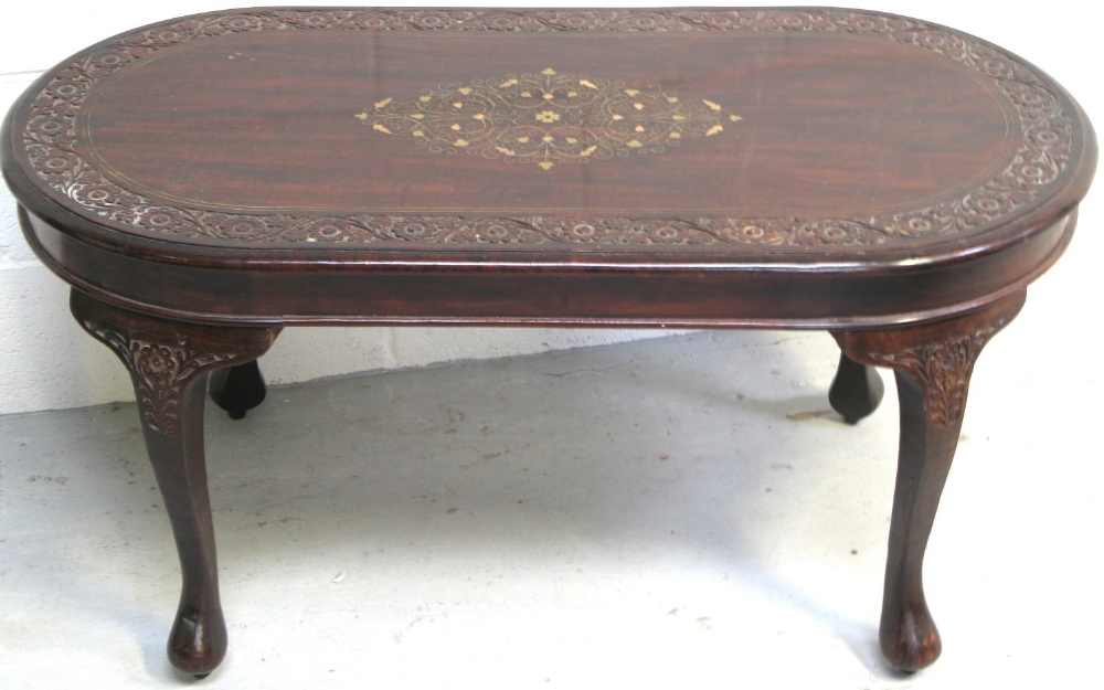 A reproduction hardwood coffee table on cabriole legs with inlaid brass decoration, length 92cm.