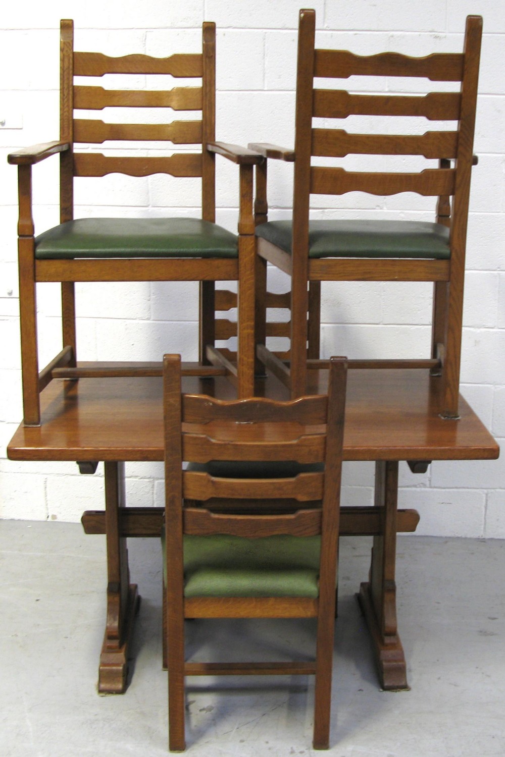 A 20th century oak dining suite comprising a refectory style table of small proportions,