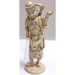 A Japanese Meiji period sectional ivory okimono depicting a gent holding a staff in his right