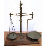 A set of larger brass hand scales on wooden plinth, height 59cm.