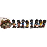 Eight assorted musical Golly figurines and red Golly alarm clock (9).