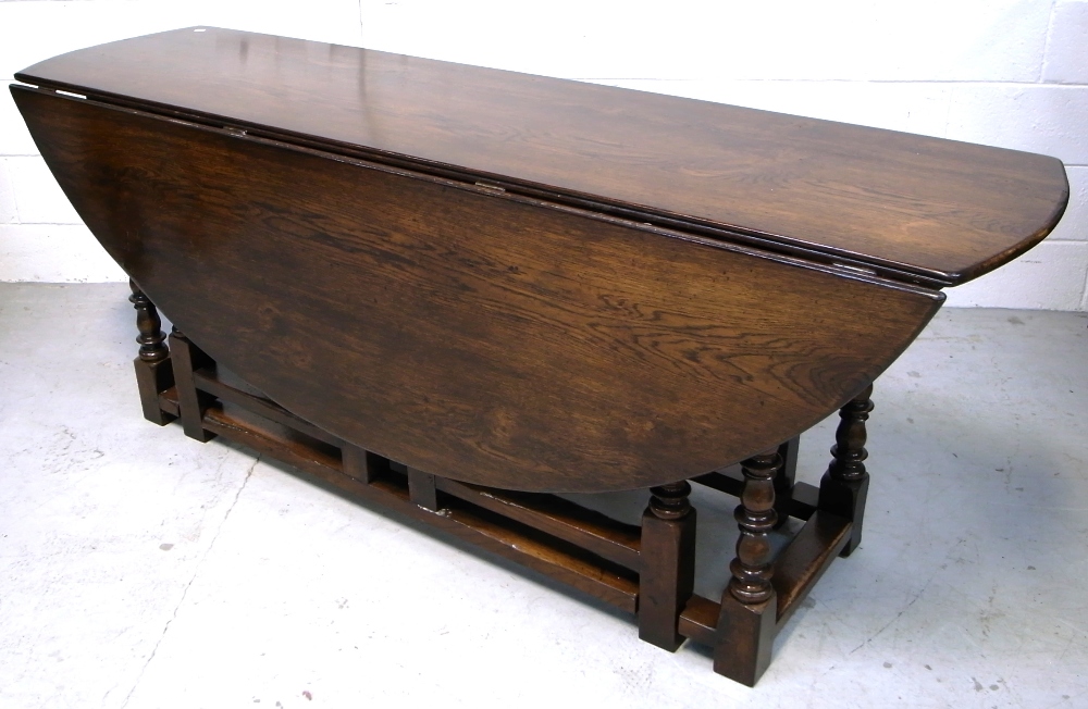 A large oak oval drop leaf table on turned gate leg supports, length 190cm, - Image 2 of 2