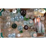A quantity of chemists bottles and jars, measuring jugs etc.