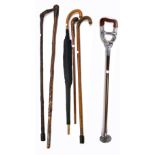 Five walking canes and an umbrella with a yellow metal collar (6).