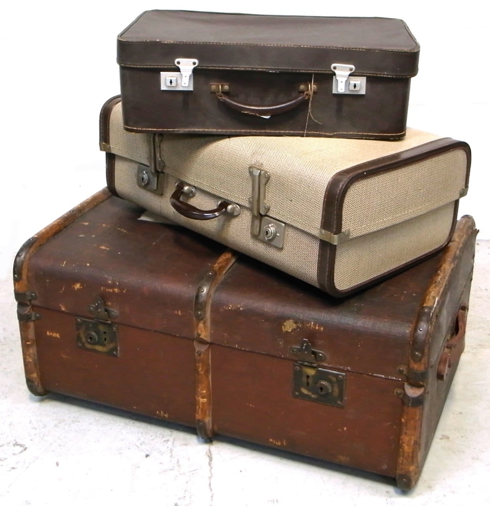 A 20th century leather and wooden bound travelling trunk with brass fittings and two vintage