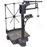 A Victorian / Edwardian cast iron industrial weighing machine with weights.