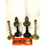 A pair of 20th century green glass lustre and wooden oil lamps with stepped bases,