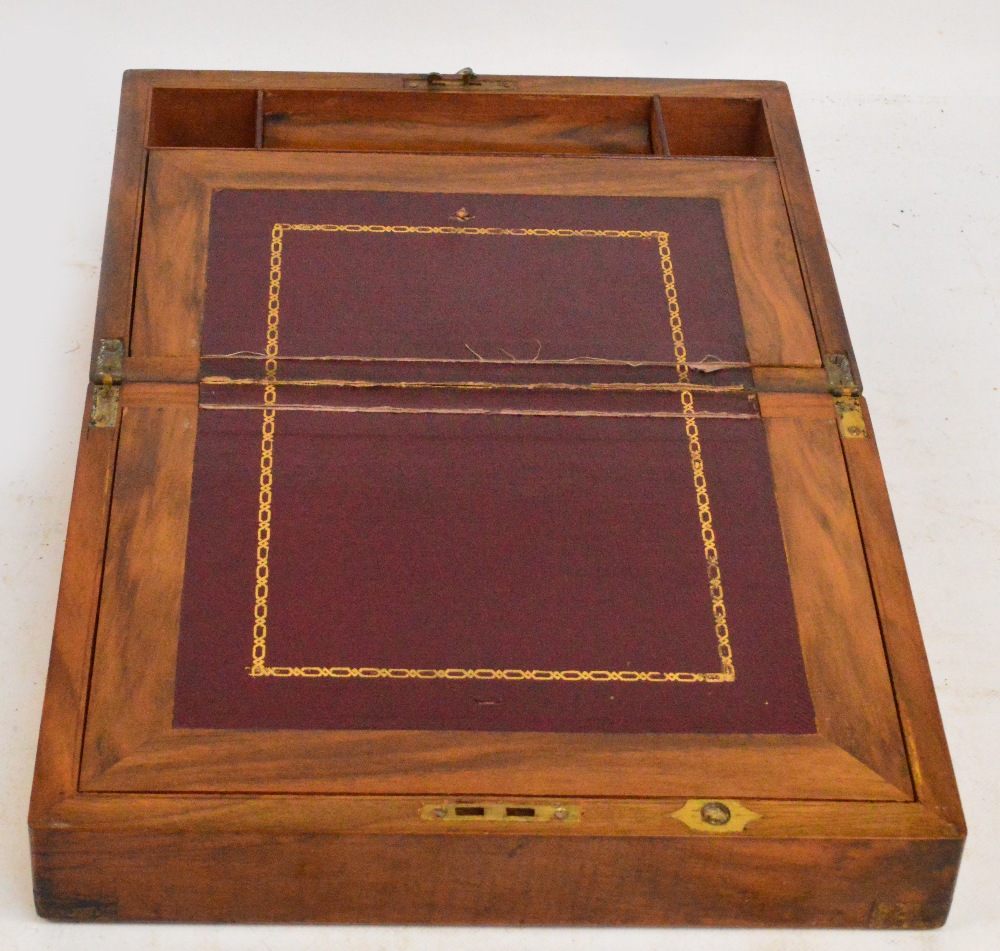 A Victorian walnut and brass bound writing slope of small proportions with compartments to the