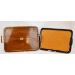 An oak twin handled rounded rectangular tray with brass gallery and central plaque,