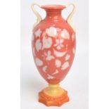 A Locke & Co Worcester pâte-sur-pâte coral and white twin handled footed vase of urn form, the