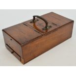 An Edwardian oak smoker's box with central handle to a rising compartment flanked by further hinged