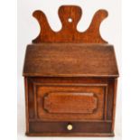 An early 19th century oak salt box,