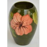 A Moorcroft vase of ovoid form in "Hibiscus" pattern, with tube line decoration on a green ground,