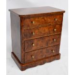 A miniature chest of four graduated drawers to plinth base, width 29.5cm. CONDITION REPORT: The