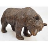 A late 19th century Black Forest carved figure of a bear, standing four square, height 21cm,