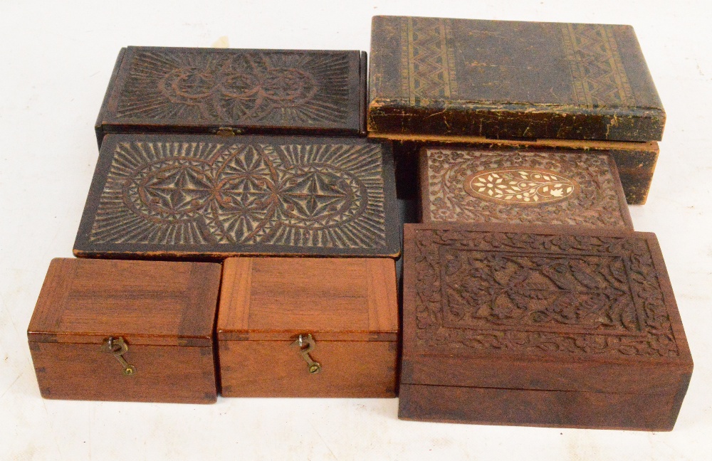 A collection of seven trinket boxes including a pine simulated strap inlaid example,