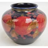 A William Moorcroft squat baluster vase in "Pomegranate" pattern on blue ground, impressed marks and
