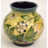 A modern Moorcroft squat baluster vase in "Fruit Garden" pattern by Nicola Slaney, with blue