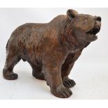 A large late 19th century Black Forest carved figure of a bear standing four square with open