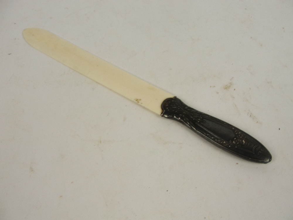 An early 20th century paper knife with ivory blade and white metal handle, length 29cm.