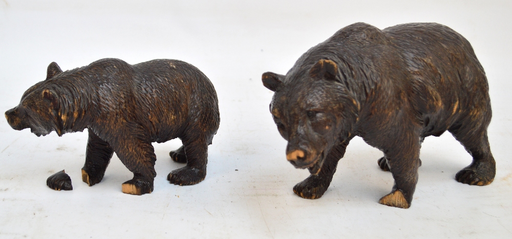 A late 19th century Black Forest carved figure of a bear, standing four square, length 23cm,