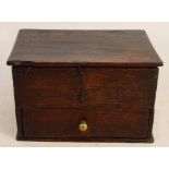 A small 18th century oak box with pin hinged lid and single drawer to the base with remnants of