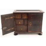 An 18th century oak spice cabinet, the rectangular moulded top above twin cupboard doors enclosing