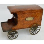 An unusual late Victorian oak smoker's table top compendium modelled as a cart with four brass