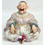 A large late 19th century French porcelain nodding pagoda figure depicting a seated Chinese man,