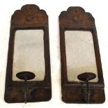 A pair of 18th century oak wall sconces, each with star inlaid shaped back plates, central