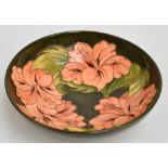 A Moorcroft bowl in pink "Hibiscus" pattern on green ground,