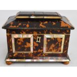 A mid 19th century tortoiseshell and mother of pearl inlaid sarcophagus tea caddy, with two