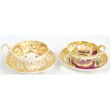 Two 19th century hand painted and gilt heightened cabinet cups and saucers, Staffordshire, one by