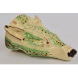 A late 18th century creamware stirrup cup modelled as the head of a fox, with painted green and