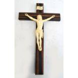 A late 19th century sectional ivory figure of Jesus, on later rosewood cross, with "INRI" plaque