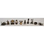 A collection of metal pencil sharpeners including examples in the form of a lighthouse, a biplane,