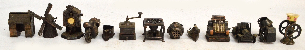 A collection of twelve metal pencil sharpeners including examples in the form of a bureau,