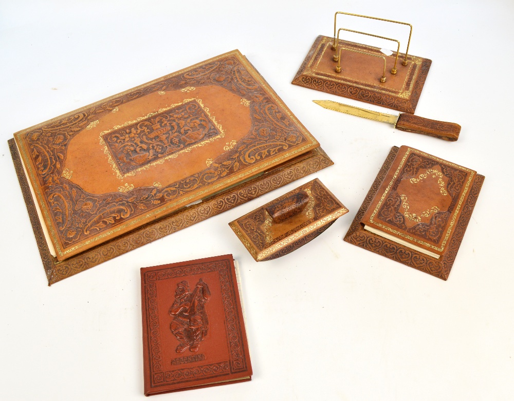 An embossed leather desk set comprising large blotting writing pad, a paper knife, stationery rack,