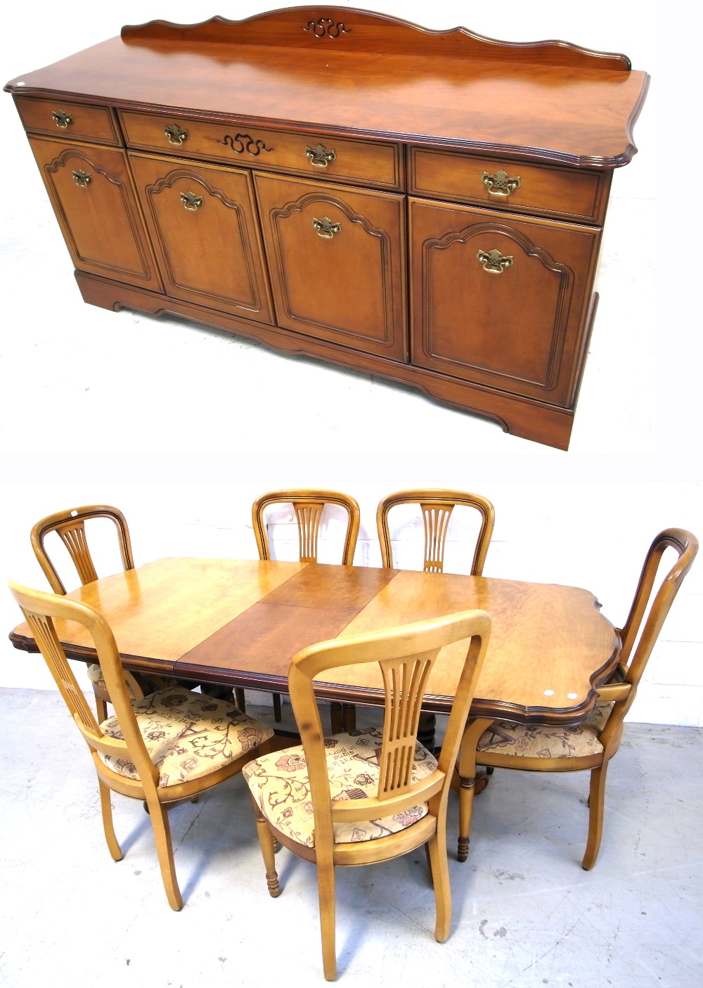 A reproduction walnut dining table on twin baluster support and stretcher,