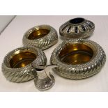 Three brass and white metal Middle Eastern bowls and a blue glass bowl with white metal overlay,