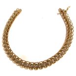 A 10ct yellow gold link bracelet set with a row of small diamonds, approx weight 9.3g.