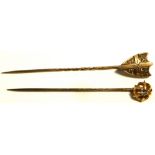 A 9ct gold stick pin with central white stone and one other yellow metal stick pin with shield