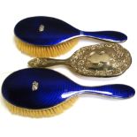 A pair of George VI hallmarked silver and enamel backed brushes, Birmingham 1947,