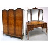 A 20th century walnut triple wardrobe on carved knee cabriole legs,