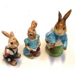 A Beswick Peter Rabbit figure and a salt and pepper both in the form of rabbits (2).