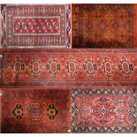 Five various red ground carpets/runners (5).