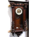 A late 19th century mahogany Vienna style wall clock with turned supports, height 85cm.